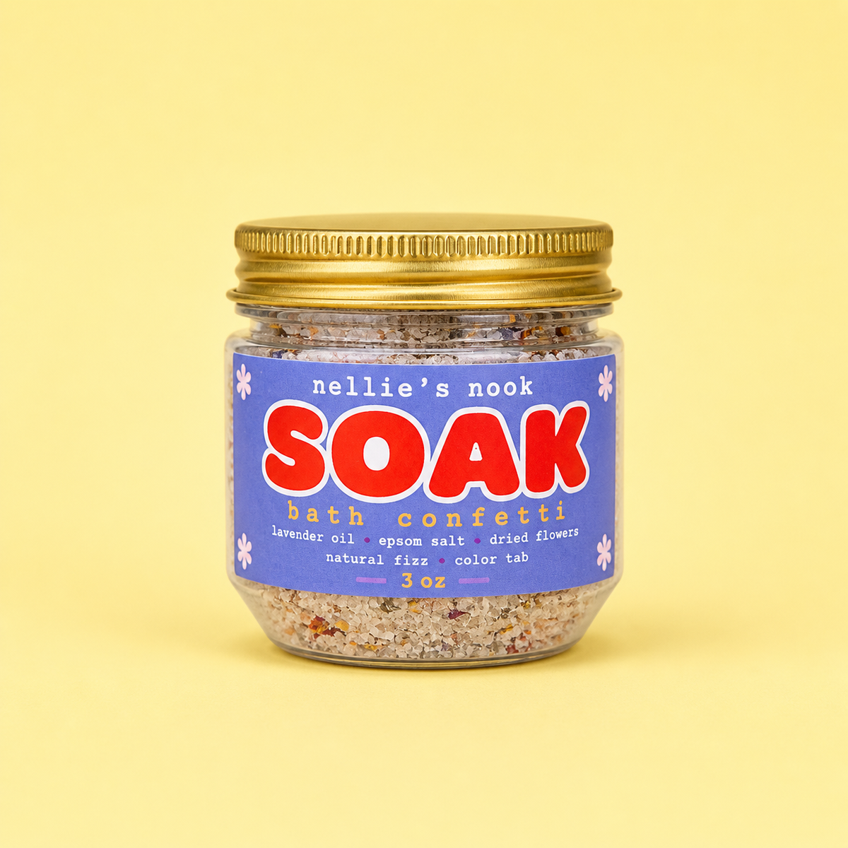 Jar of 'nellie's nook SOAK bath confetti' on a yellow background