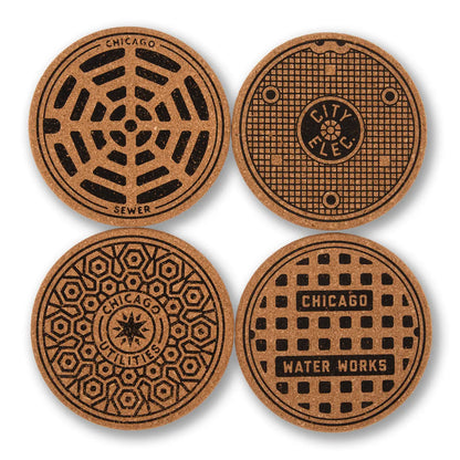 Four round cork coasters featuring Chicago manhole cover designs, arranged in a 2x2 grid on a white background.