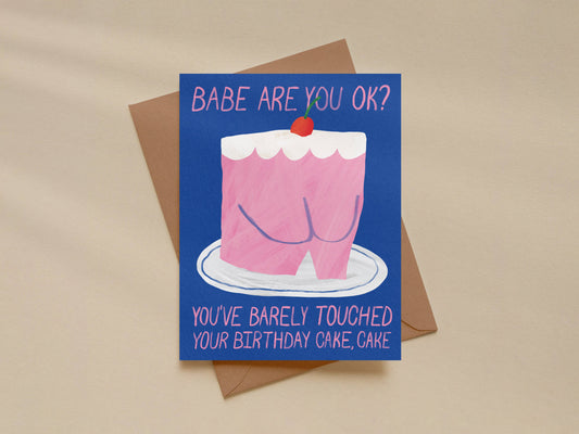 Card with a pink cake illustration and humorous text on a beige background